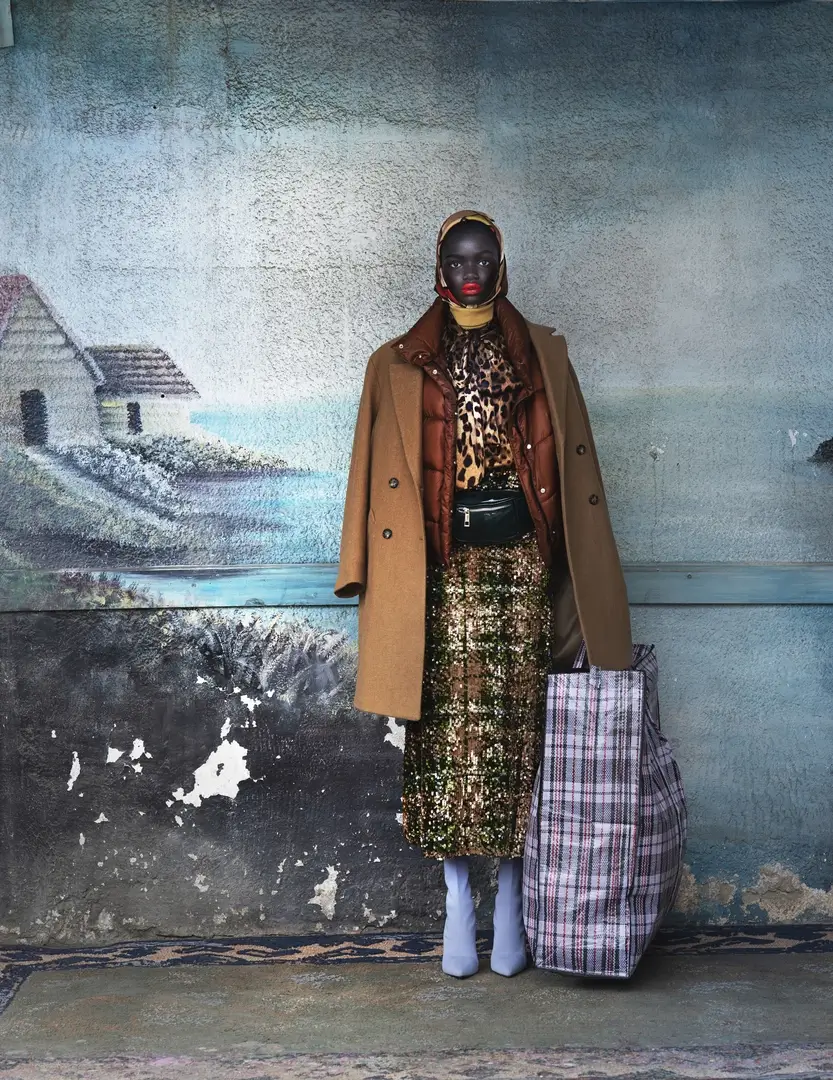 African woman shot against a wall drawing